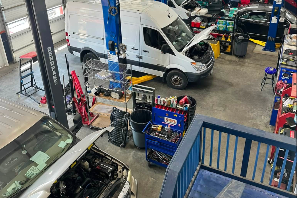 Fleet Maintenance in Woodbine MD At Kit's Auto and Truck Repair. Aerial view of commercial vans inside a repair shop bay for fleet service