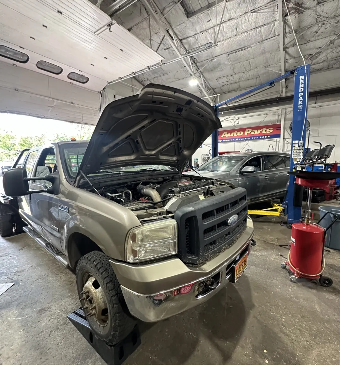 Domestic Auto Repair Service in Woodbine MD At Kit's Auto and Truck Repair. Image of Ford F-Series truck parked in a garage bay for domestic truck repair service